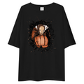 A black oversized short-sleeve t-shirt with a graphic print of a cartoon character punching a pumpkin, displayed on a solid white background.