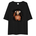 A black oversized short-sleeve t-shirt with a graphic print of a cartoon character punching a pumpkin, displayed on a solid white background.