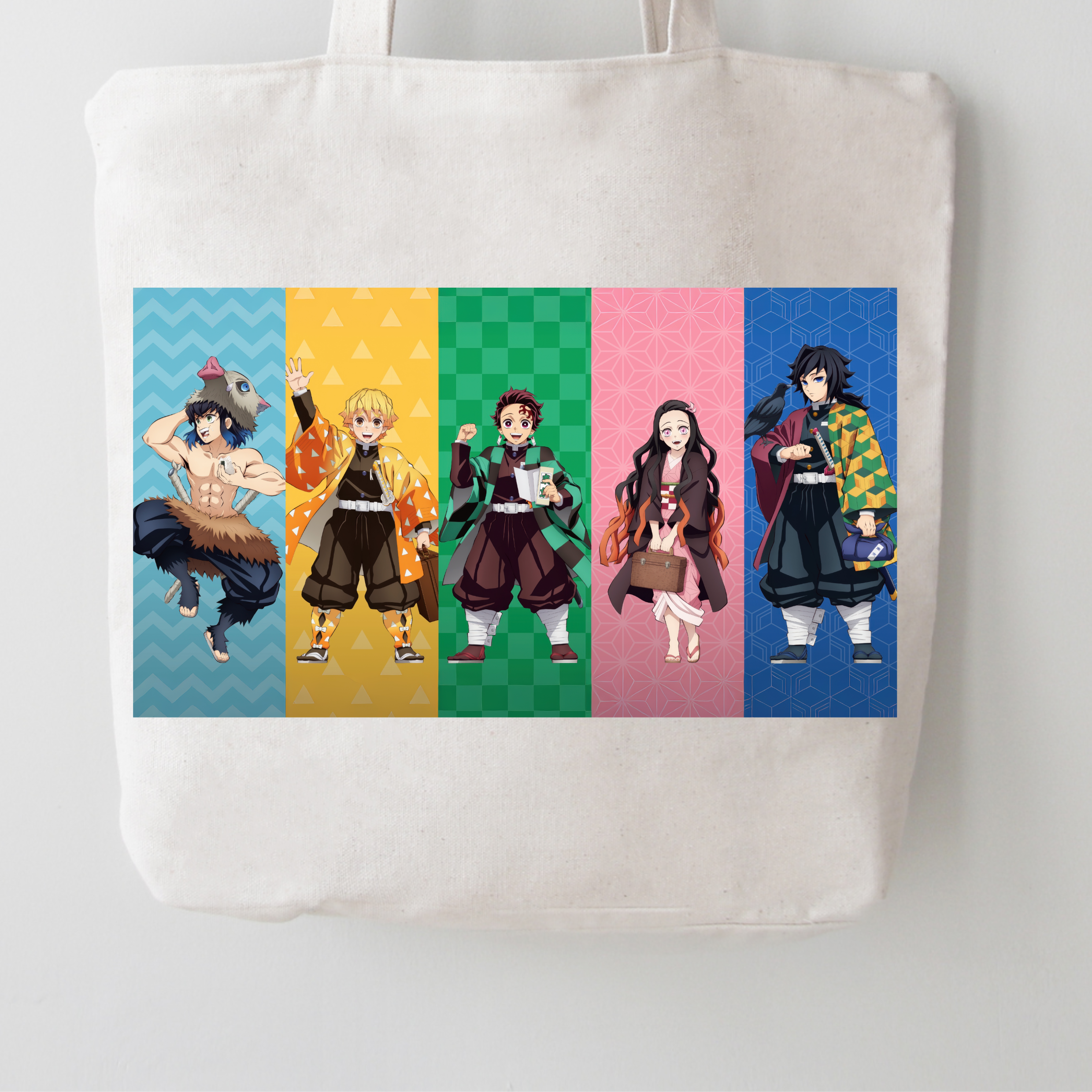 A white canvas tote bag featuring a colorful graphic print of five anime characters in vertical panels on a light gray background.